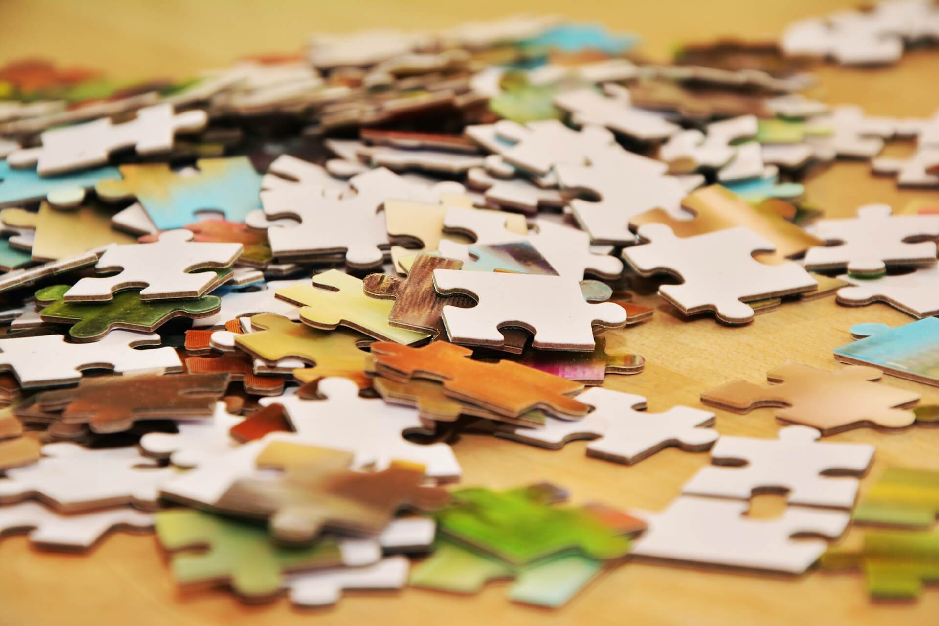 An image of a pile of puzzle pieces. An HR organization has all the necessary pieces for employee onboarding, but hasn't created a process for it yet.