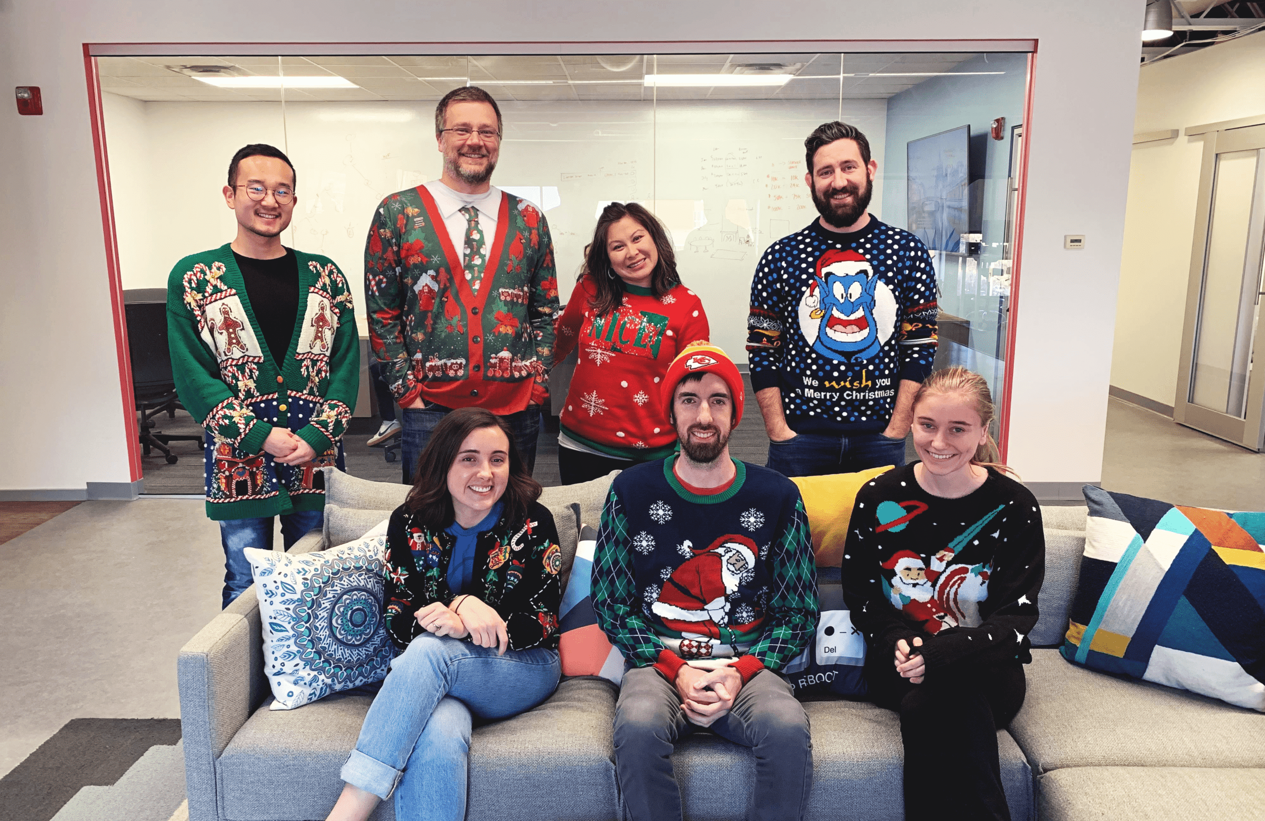 The Capacity team wearing ugly Christmas sweaters