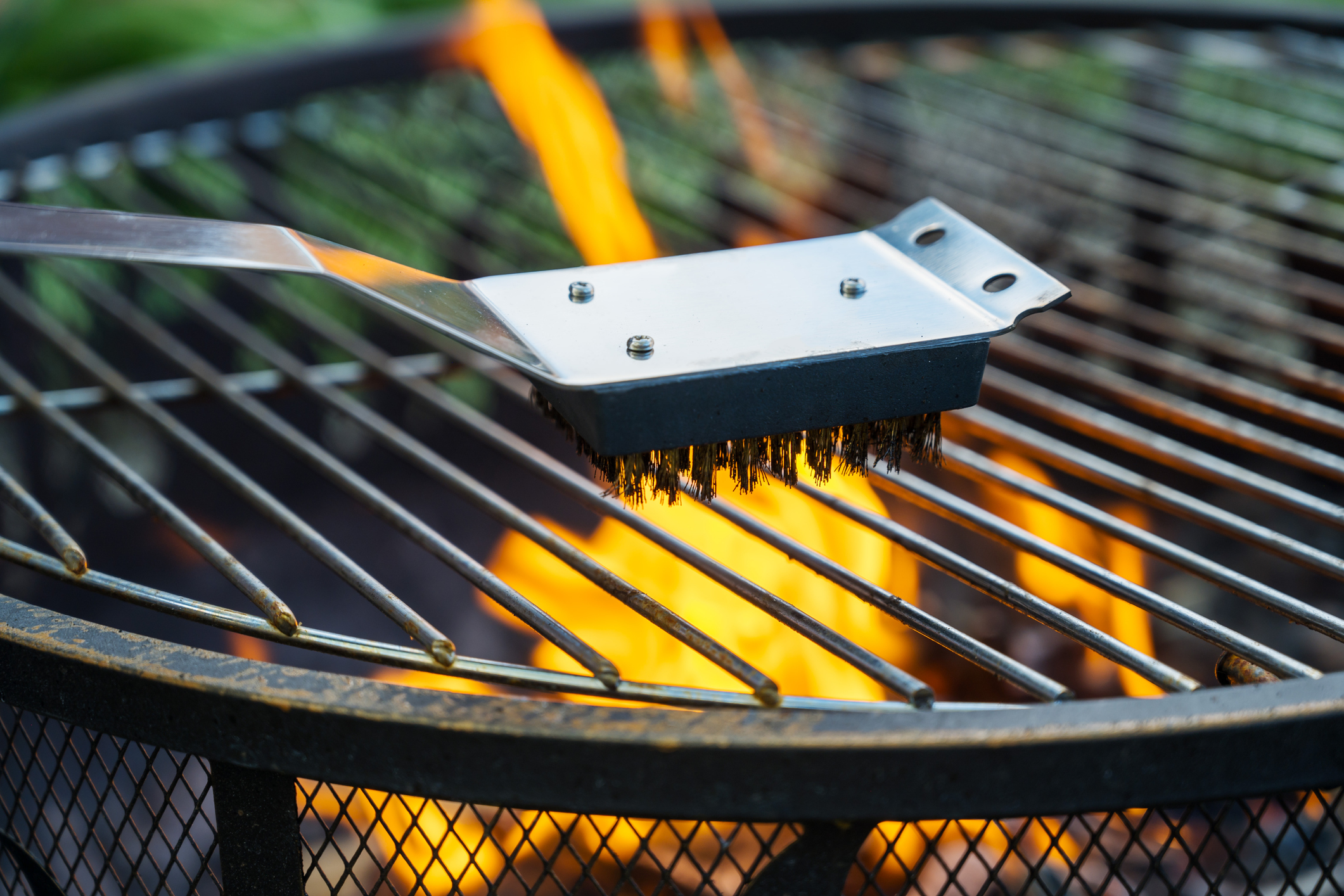 Clean the grill grate. Brushing the metal iron barbecue grill after cooking.
